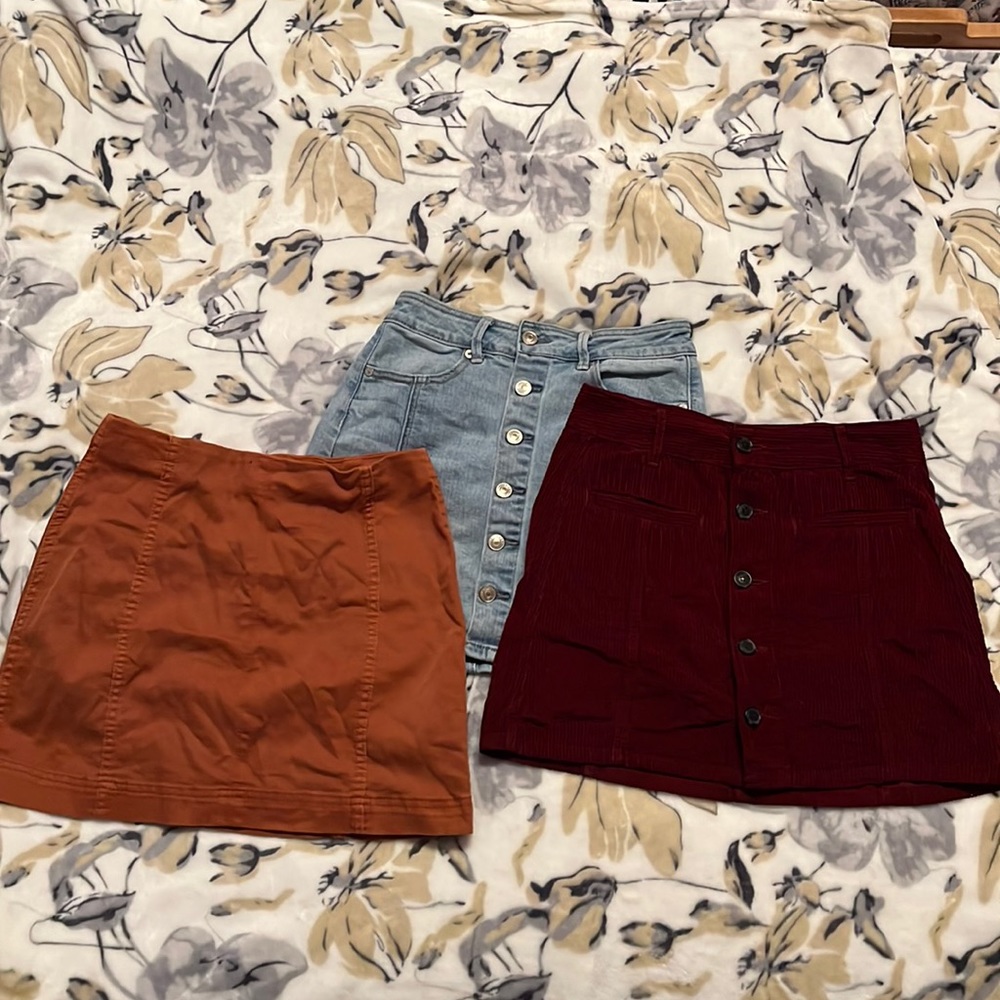 Two skirts are a 0 and the other one is a small. Fit the same. as good as new